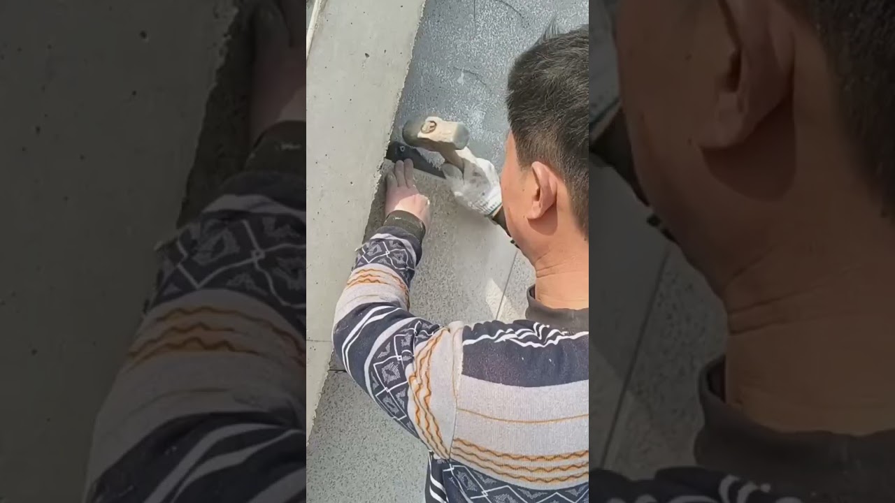 the process of installing marble tiles on the walls outside the building 