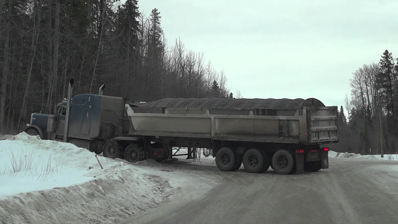 Semi Truck with road chains Stuck on deadly ice road Near Grande Prairie Alberta Canada