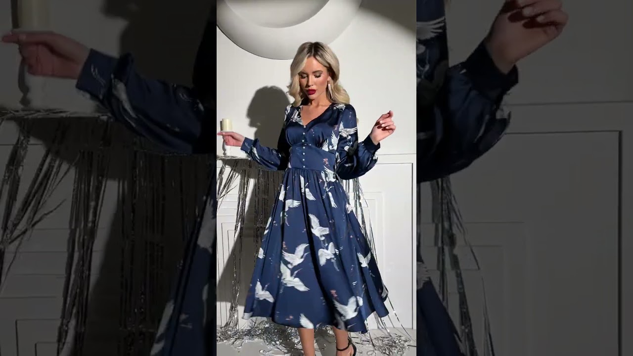 A model tries on a dress with cranes in a deep sapphire color 👙 #fashion 👖 #style  👚 #shorts