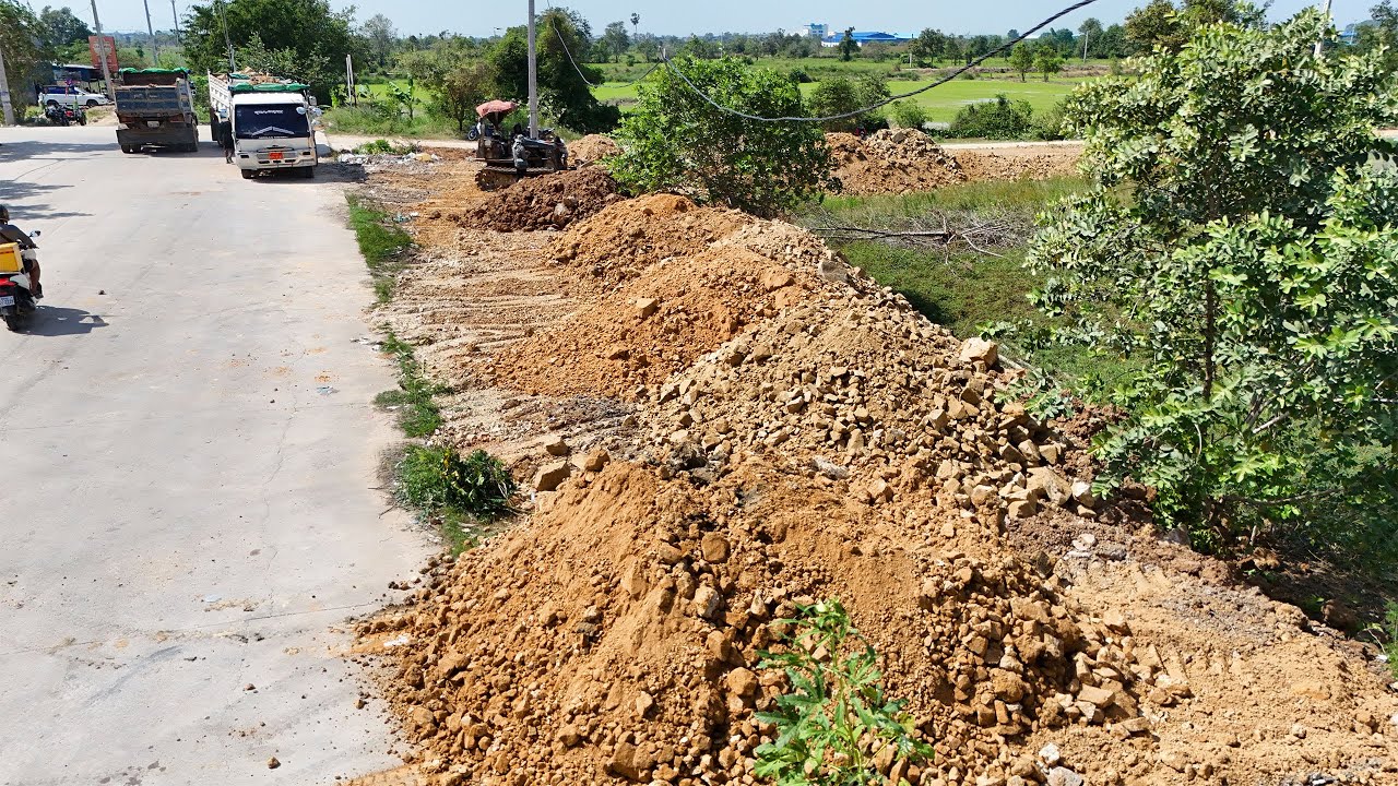 Great Start! Skillful Land Filling in Action — Dozer and Dump Trucks Working in Perfect Coordination