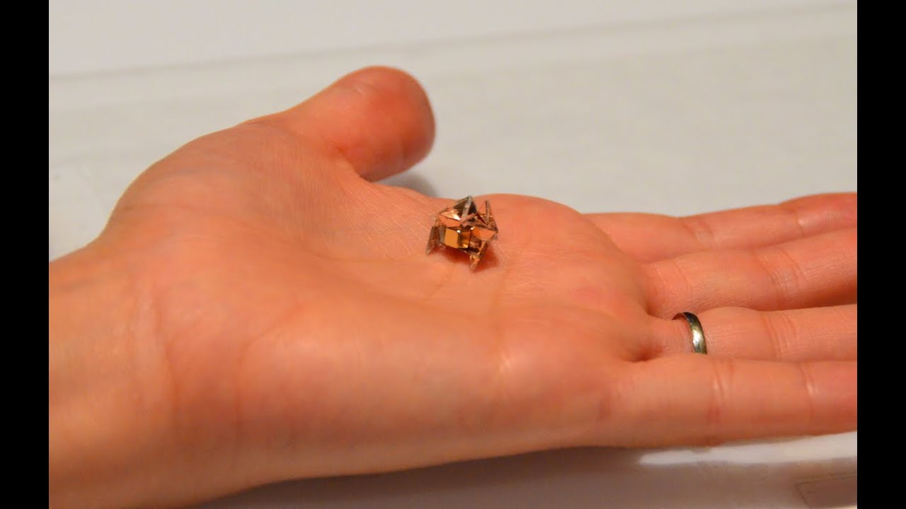 Miniature Origami Robot Self-folds, Walks, Swims, and Degrades