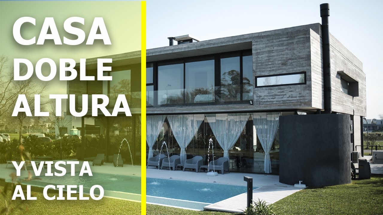 CASA DE HORMIGON CON DOBLE ALTURA Y GRAN VENTANAL SUPERIOR