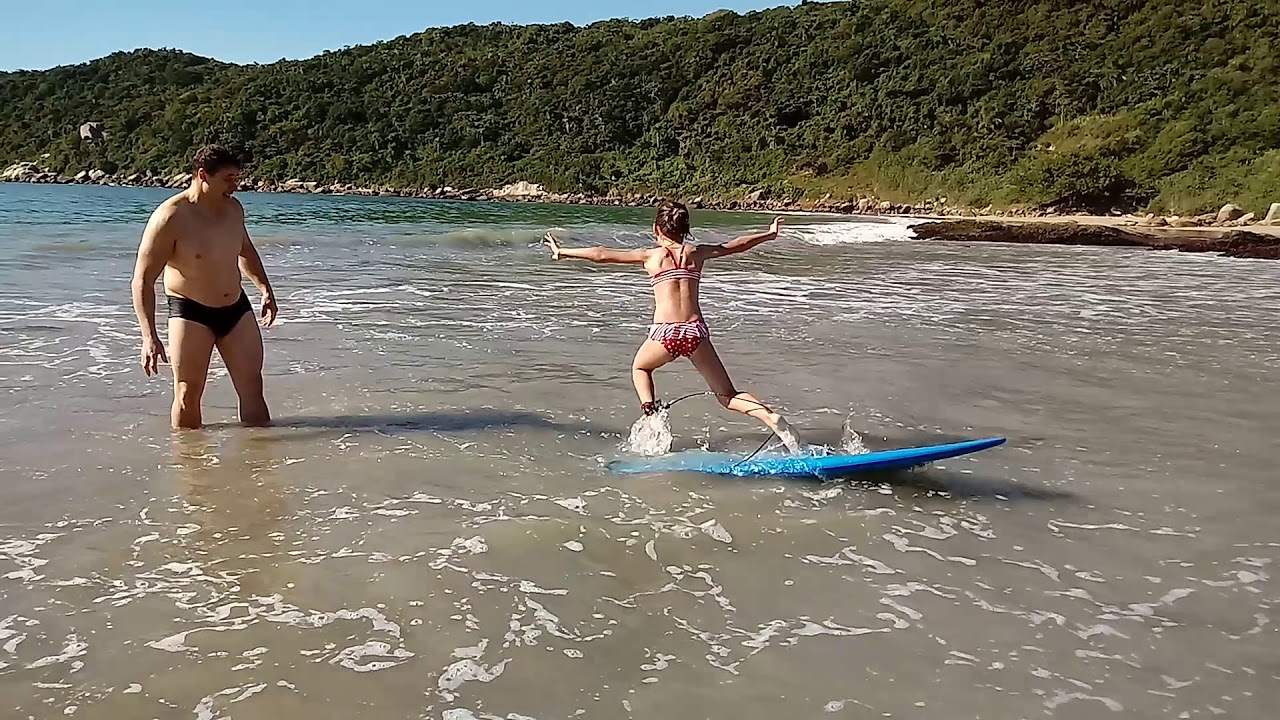Ensinando a filha a surfar na praia dos padres