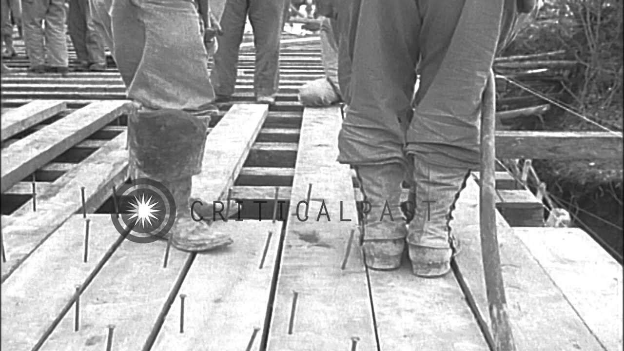 U.S. 5th Army vehicles traverse bridges at Volturno River near Mignano, Italy, in...HD Stock Footage