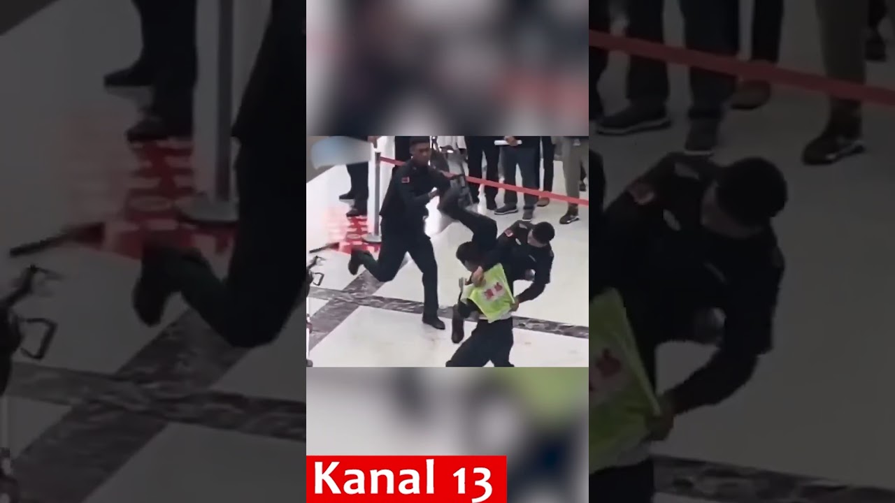 Chinese police officer subduing a criminal during a raid