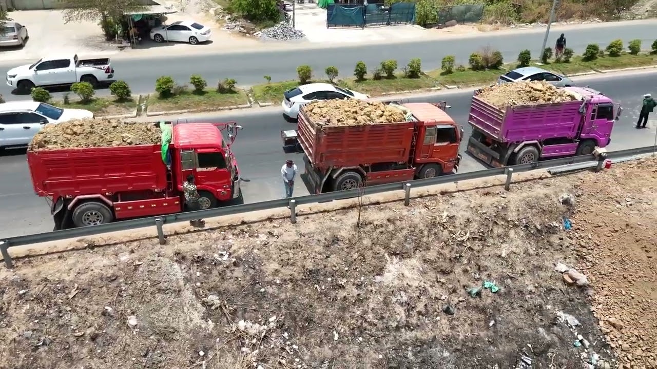 EP02,Activities: Development: Beginning a new road project with a skilled dozer pushing a dump truck