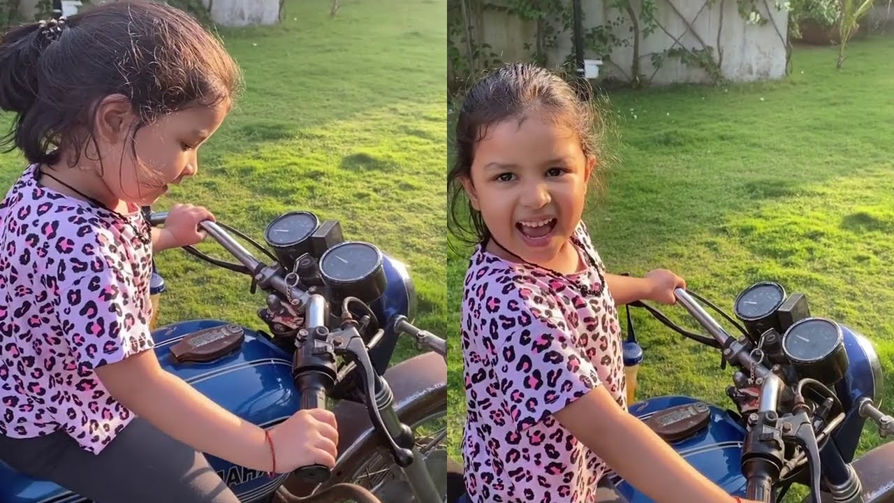 watch Video of Ziva Dhoni With MS Dhoni looks cute as she love to accelerate bike .