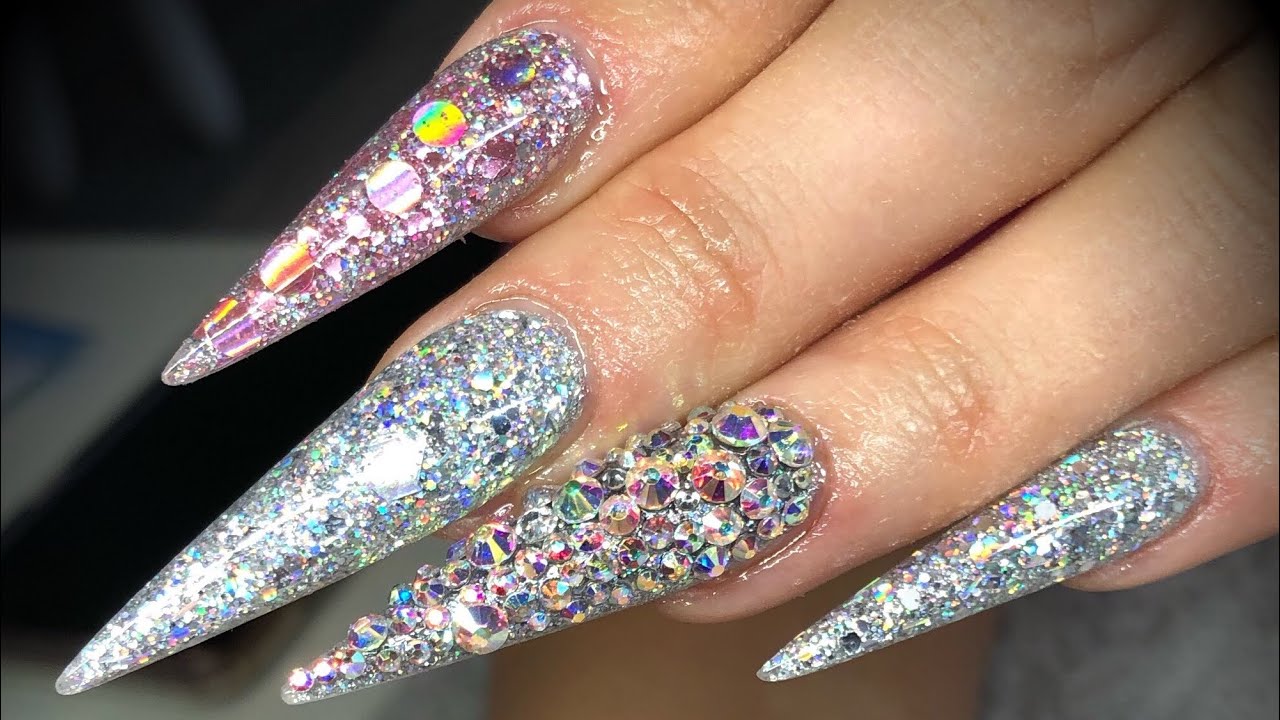 Acrylic nails - extreme length stiletto glitter design set with swarovski crystals