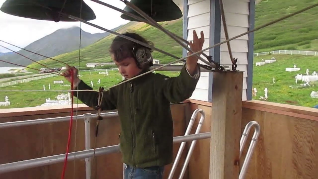 Eight year old Alaskan boy plays the Belkofski church bells in Alaska. (June, 2018)