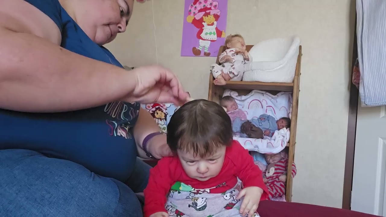 Changing Benjamin into his christmas outfit. 