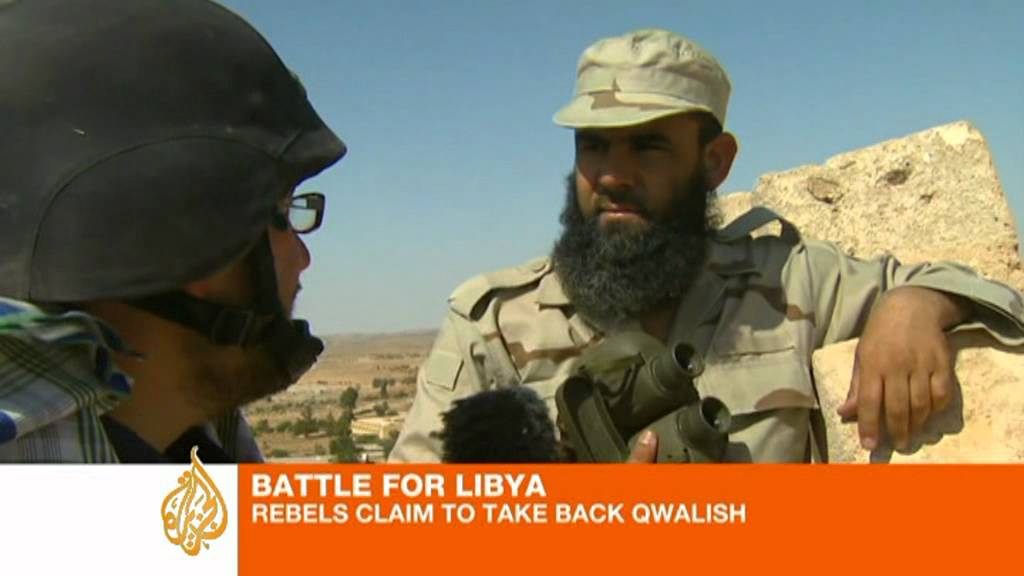 Libyan forces and rebels fight over mountain town