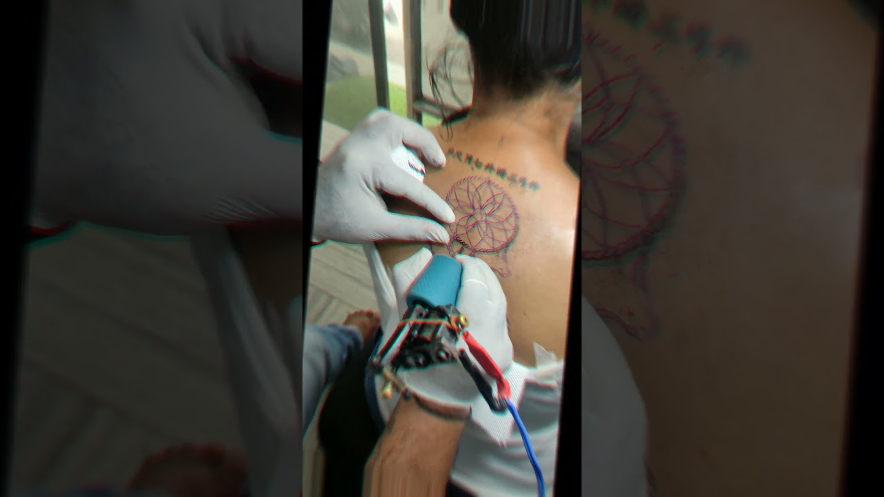 dream catcher tattoo on Back for woman