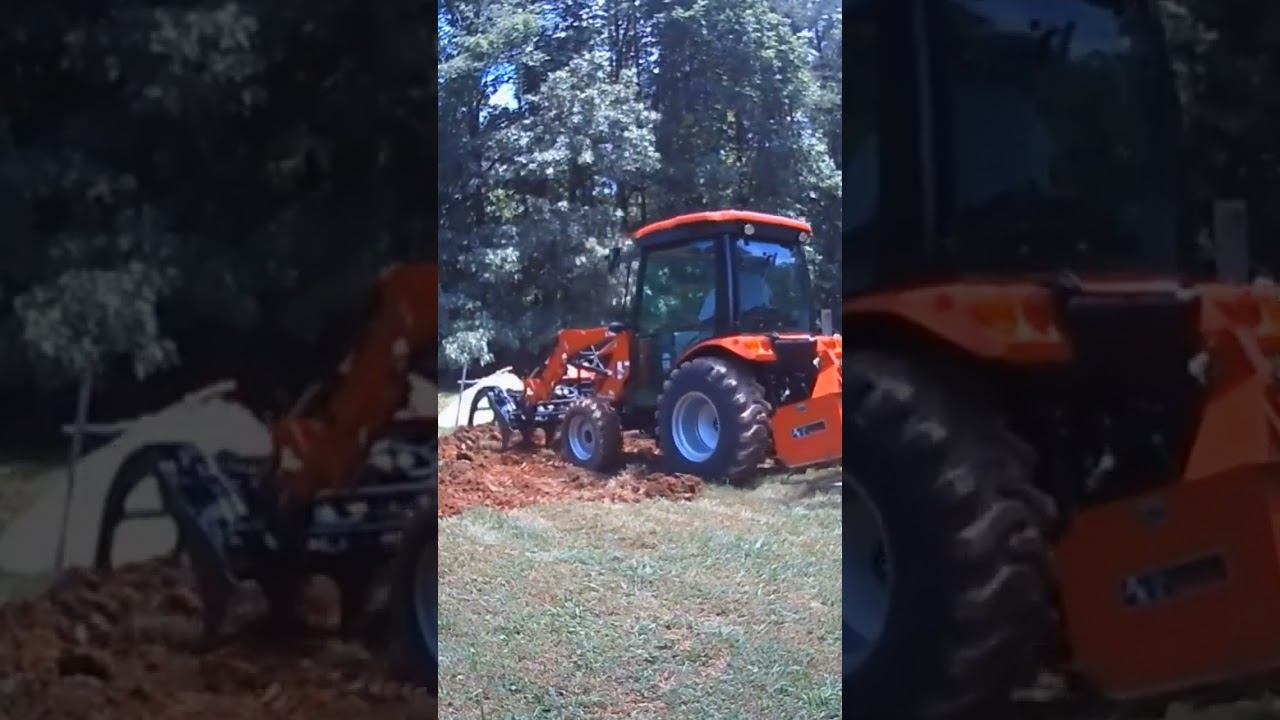 Rural King RK37SS tractor using the granite grapple to make a garden