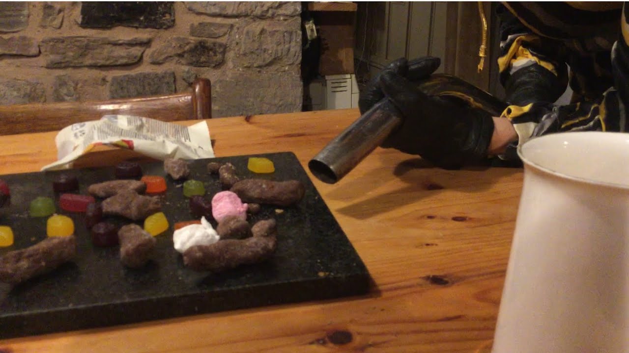 Bin-drop vacuum bag, vacuuming sweets, chocolate turds, wine gums, with leather gloves