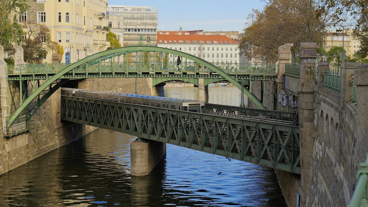 Historic Zollamtssteg Bridge across the river with subway train traveling underneath, Vienna Austria