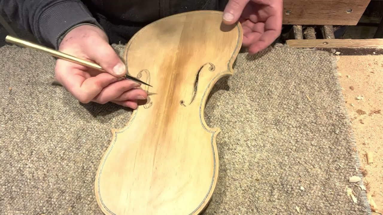 #77 - Knife cutting violin f-holes.