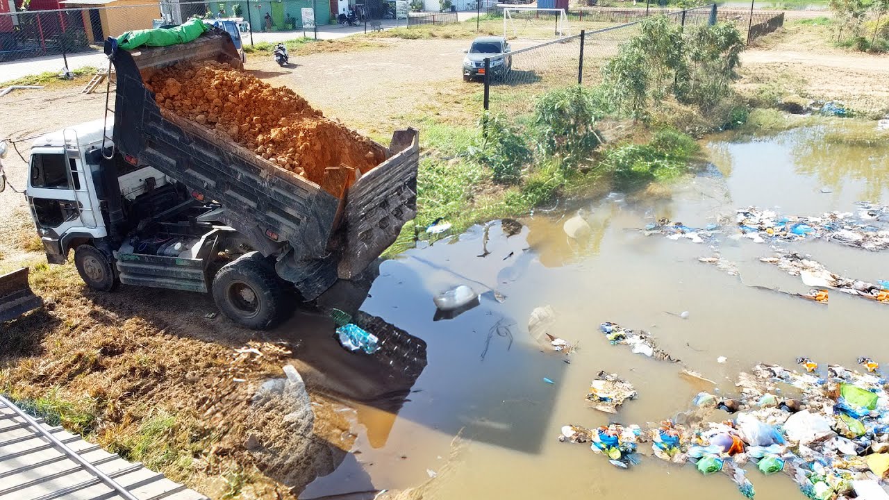 New Project to Remove Flood Cleanup: Heavy Equipment Unloading in Wet Zone