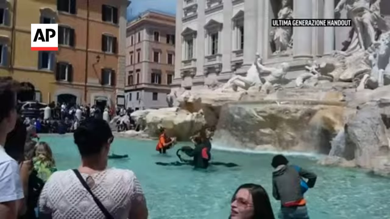 Activists pour black liquid into Trevi fountain