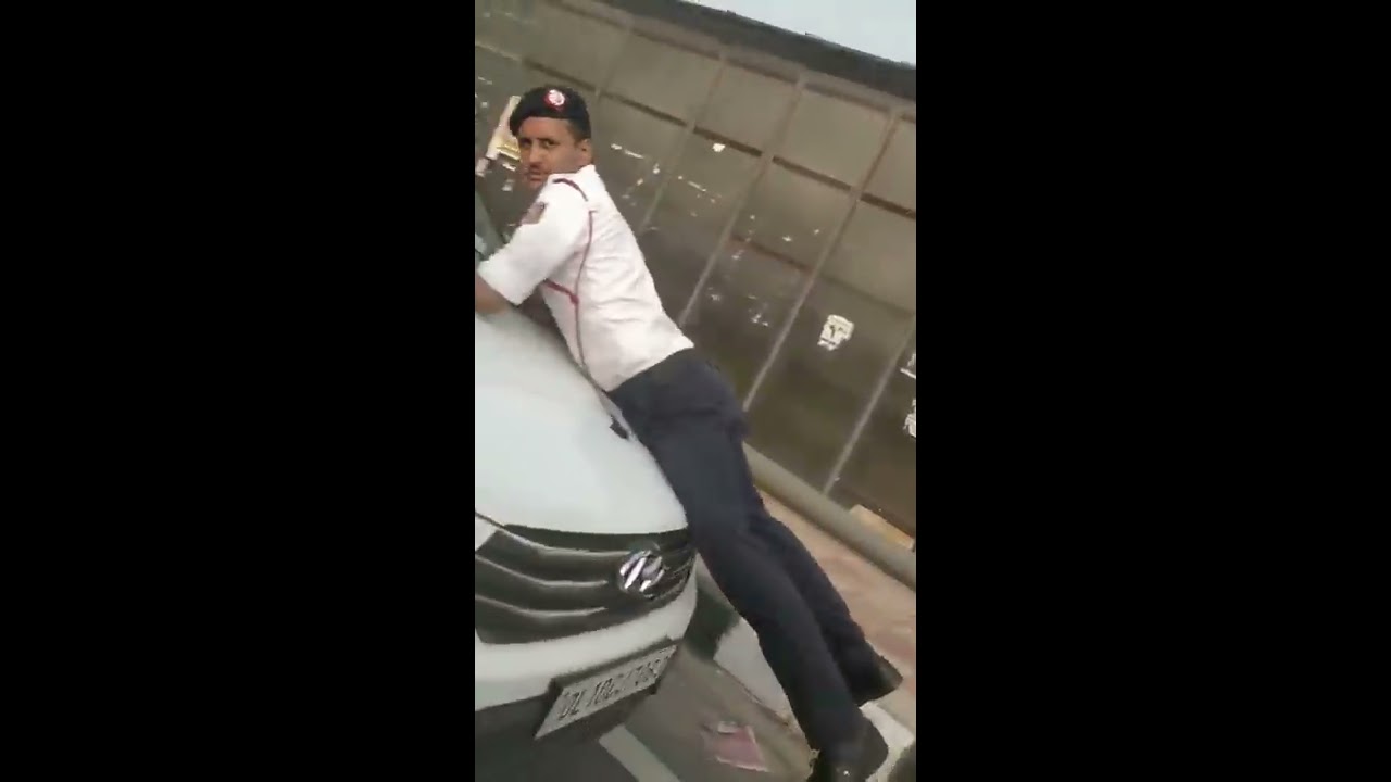 Traffic Policeman climbed on a car bonnet in an attempt to stop traffic violation