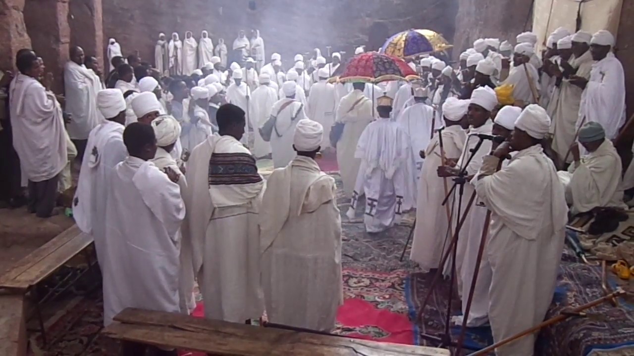 priests chanting at the gate of Saint Maryam church in Lalibela.