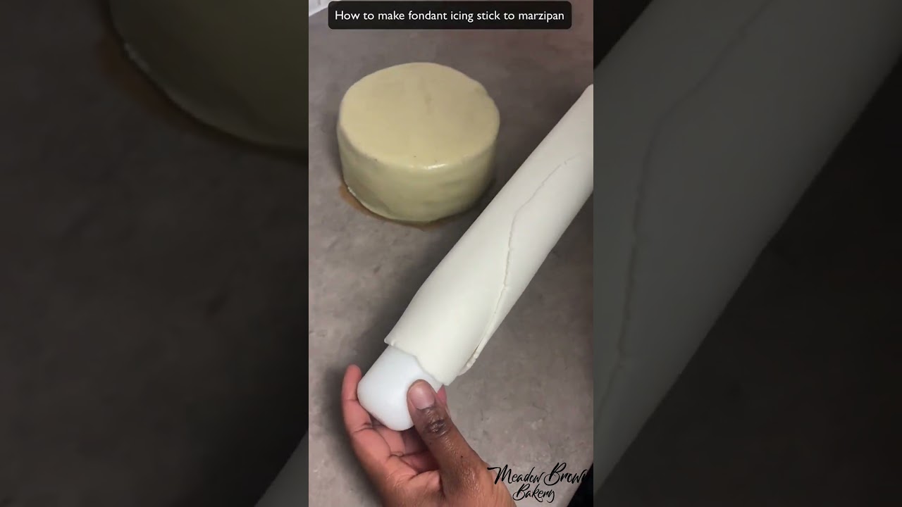 How to make fondant icing stick to marzipan : Covering a fruit cake with marzipan and fondant