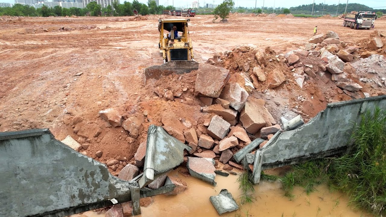 Awesome Mighty Bulldozer Strong Power Filling Large Stones Along The Fence to Protect Flood