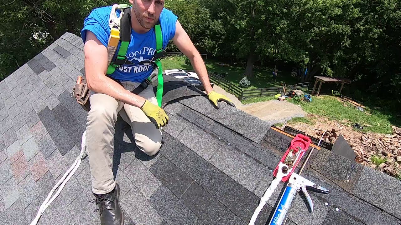 Fixing Damaged Shingles at the Roof Peak
