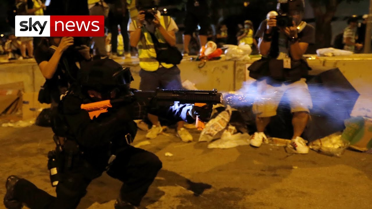 Hong Kong police rush at protesters