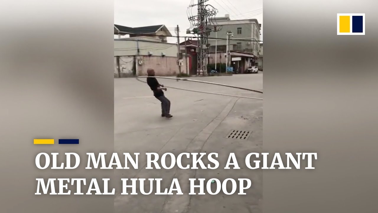 Old man works out with giant metal hula hoop