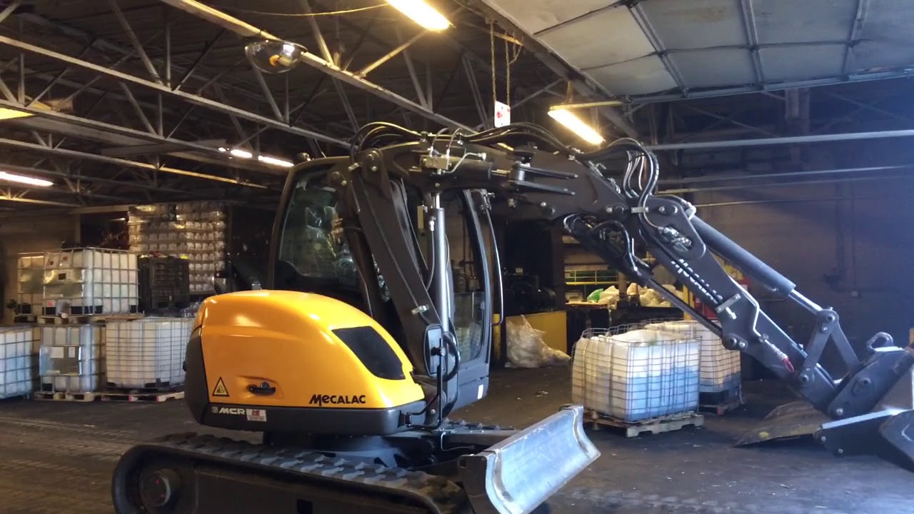 Mecalac 6MCR removing debris from a demolition site