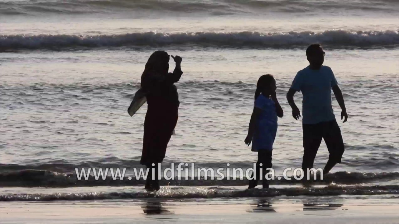 Bay of Bengal beach of Kolatoli in Bangladesh: tourists and local mill around
