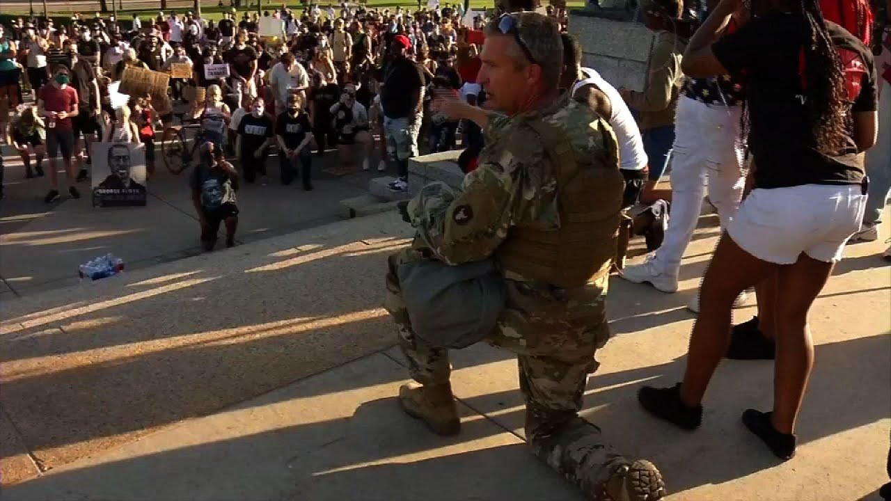 Minnesota soldier hugs protesters at Capitol