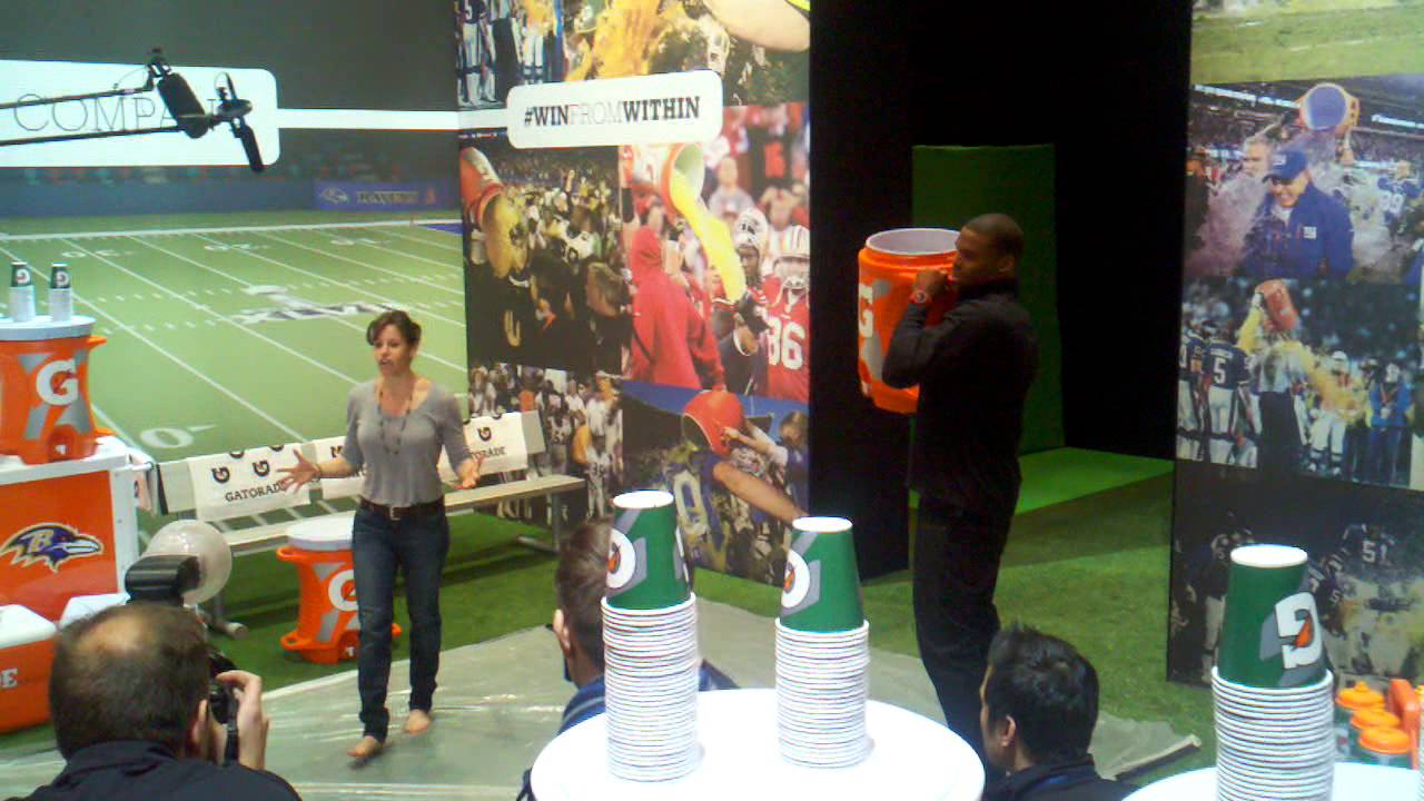 Cam Newton giving a Gatorade bath to tv chic