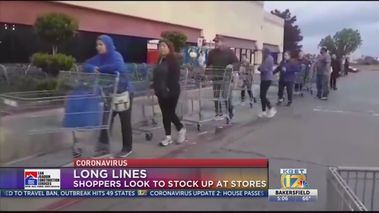 Amid COVID-19 fears, shoppers wait in long lines at supermarkets to stock up on supplies