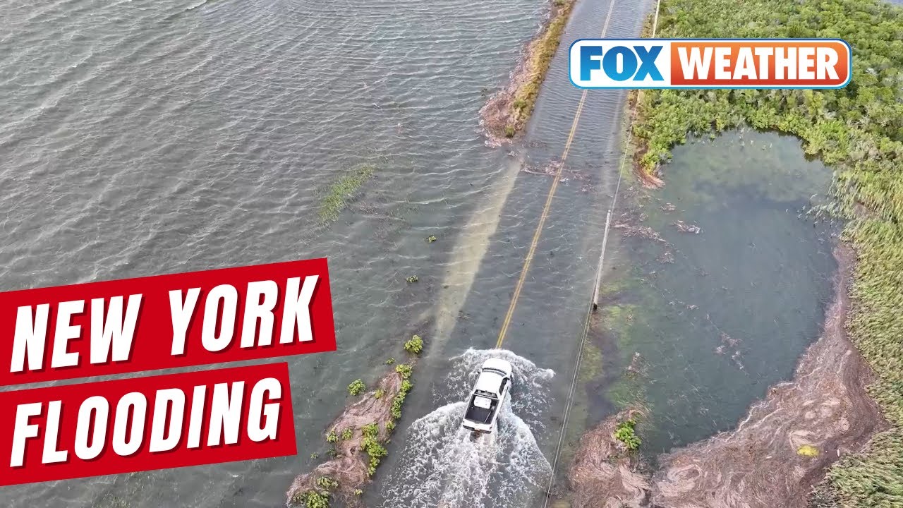 Cars Drive Through Flooding Produced By Hurricane Erin On Long Island