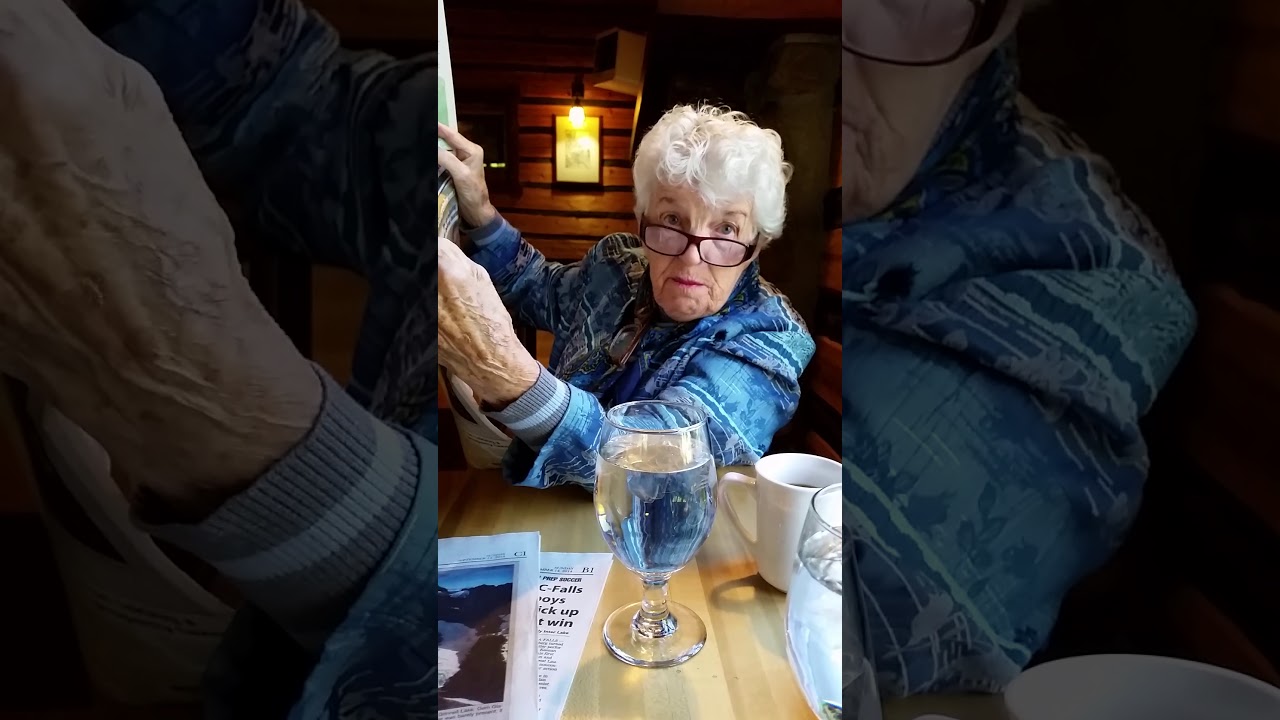 20140914  Mom reads the paper at McDonald Lodge in Glacier