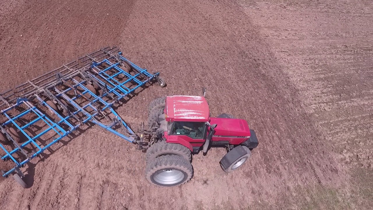 CaseIH 8950 tilling field ahead of  International Harvester 5088 planting corn
