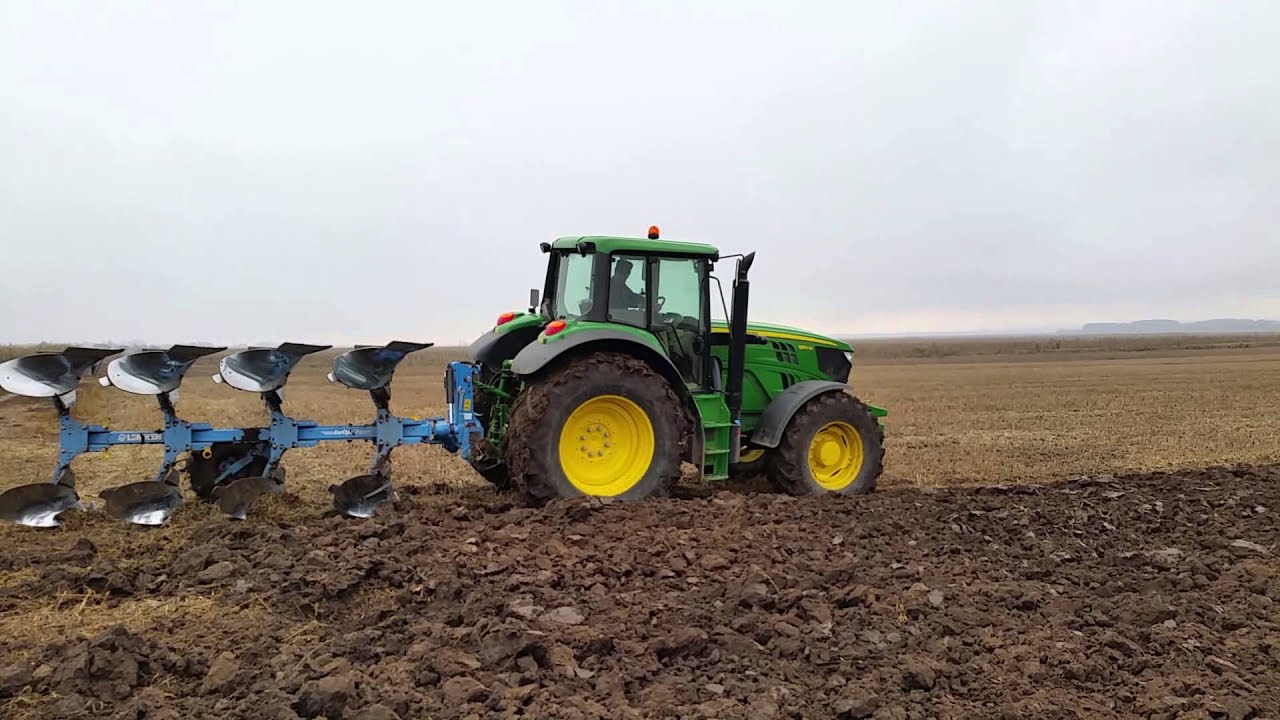 Deere 6150M ploughing