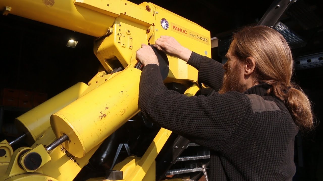 refurbishing a Fanuc robot arm.