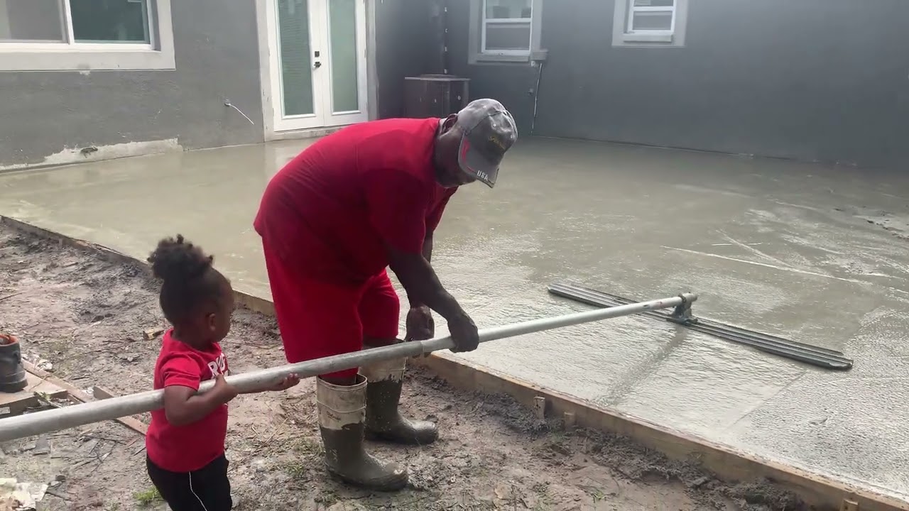 Pap teaching grandson how to float concrete 