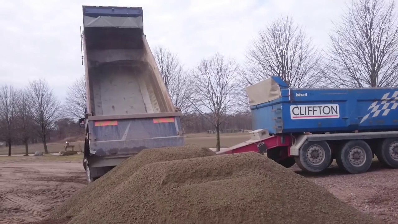 Scania With Trailer Unload Gravel. Notice the adjustable axels on trailer.