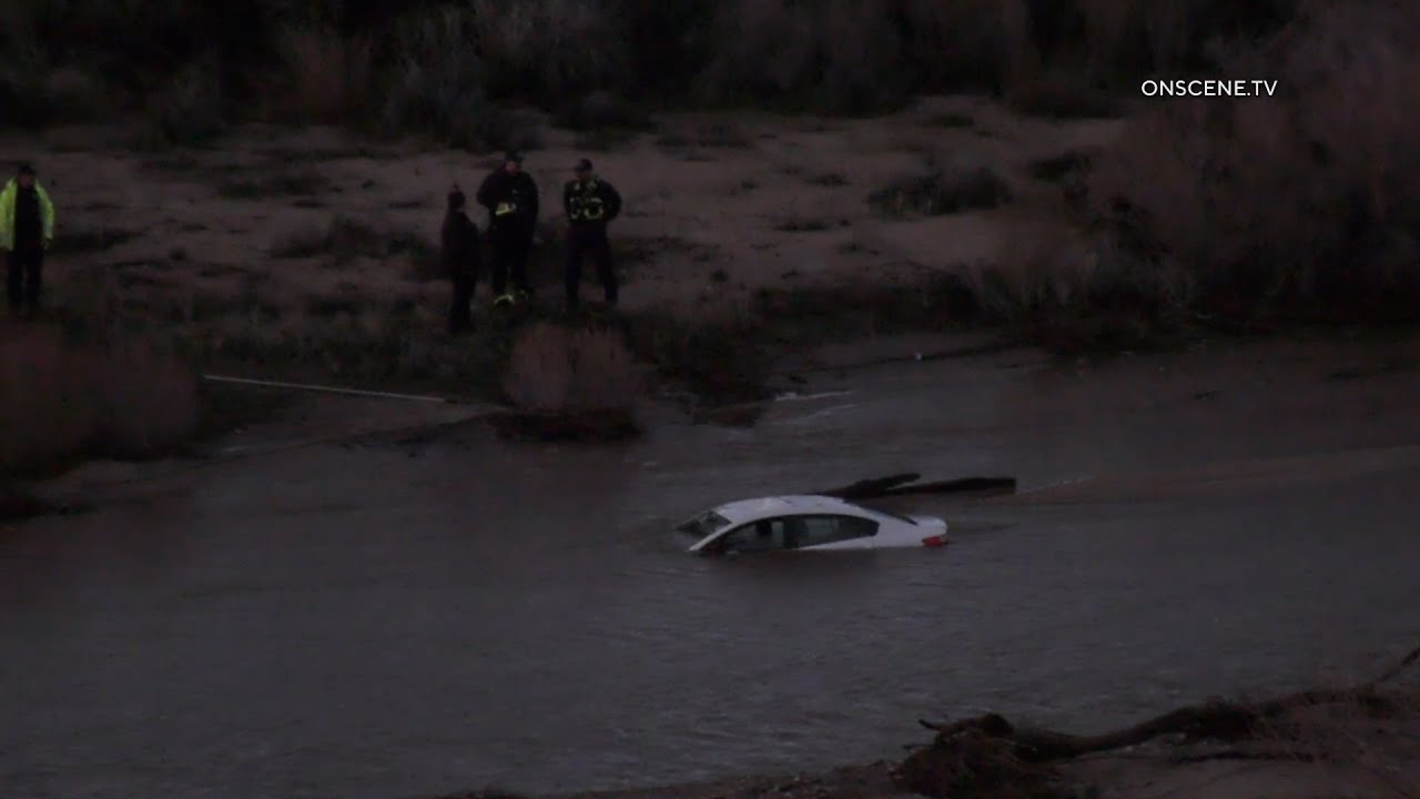 HESPERIA Authorities Respond To Car Fully Submerged in Flood Waters