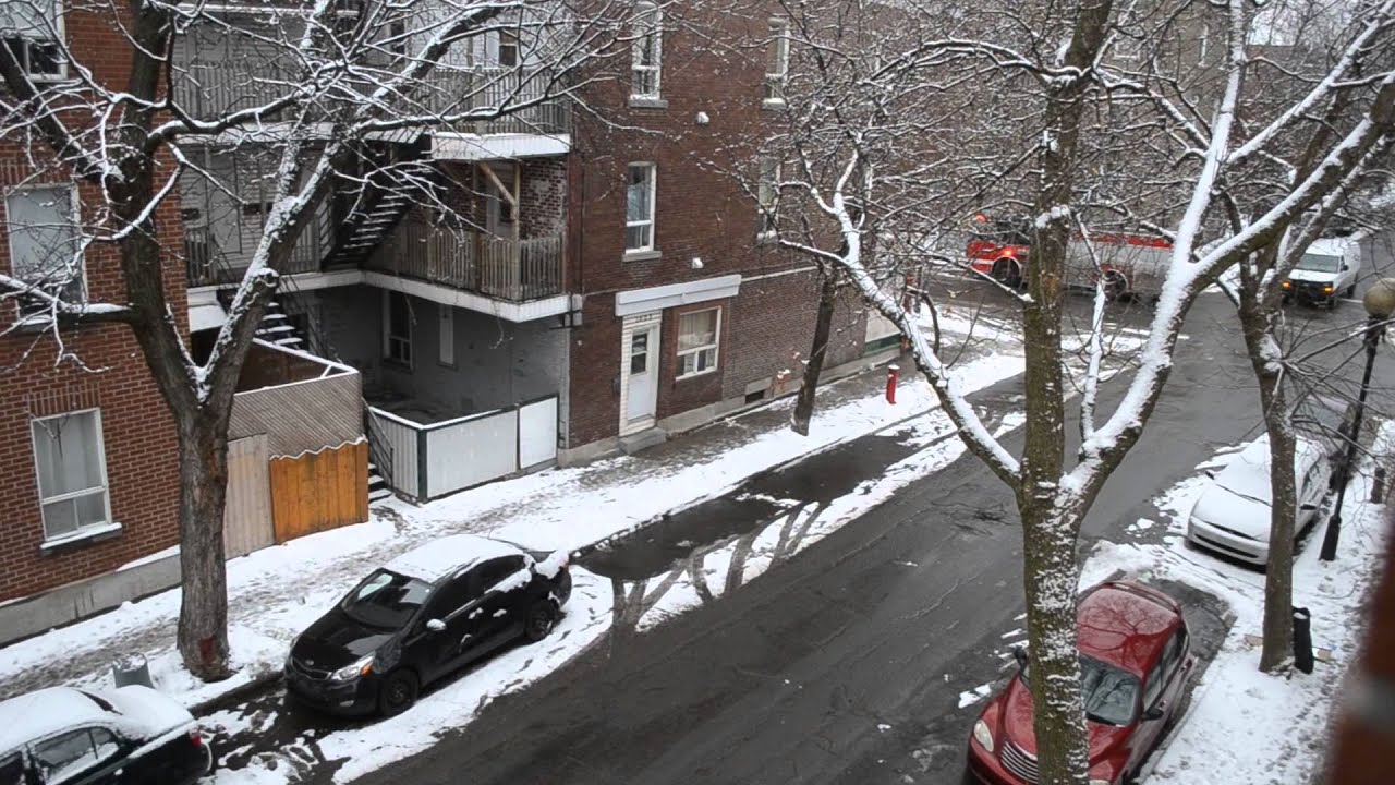 MONTREAL FIRE TRUCK RESPONDING ON STREET CORNER