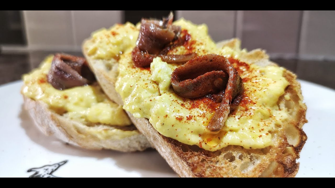 Anchovies and creamy scrambled eggs on toasted bread - Brunch ideas