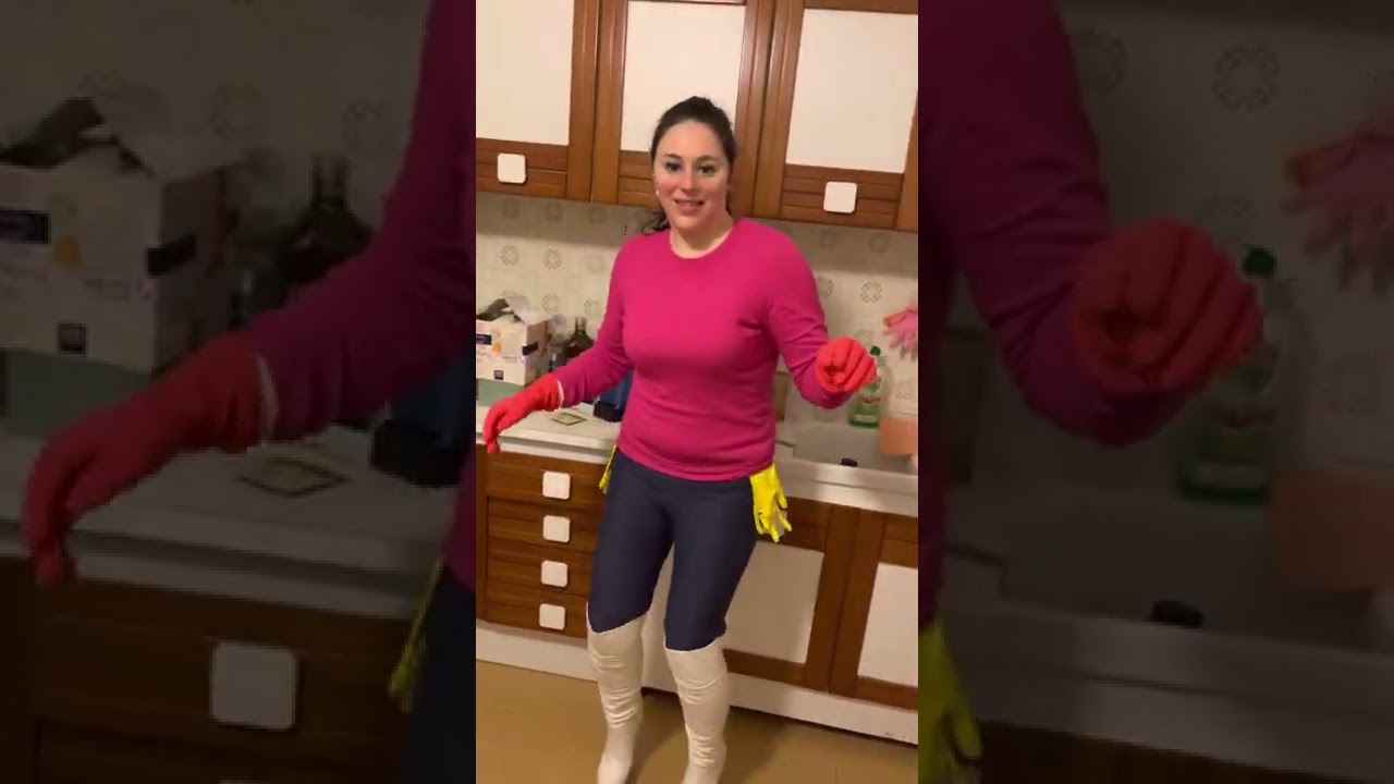 Dancing in the kitchen in rubber gloves and leather boots