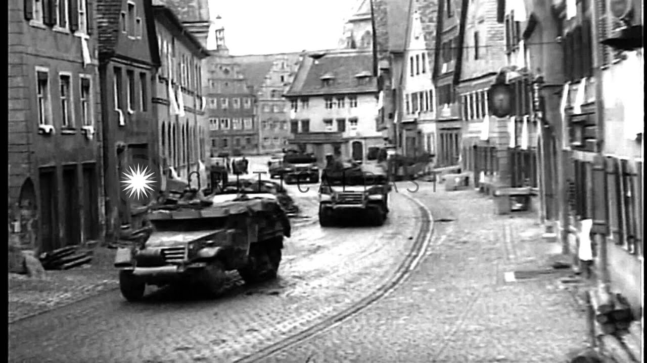 German civilians watch armored vehicles moving through streets in Dinkelsbuhl, Ge...HD Stock Footage