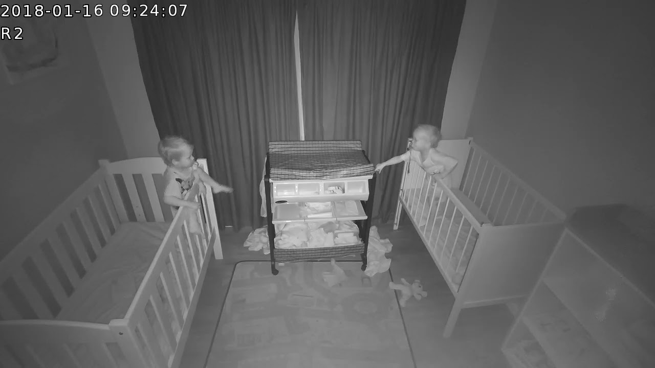 Twins climb out of cots