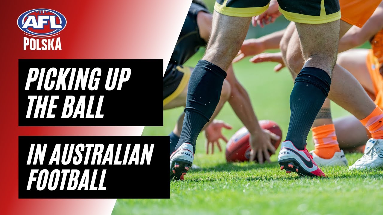 Picking up an AFL ball