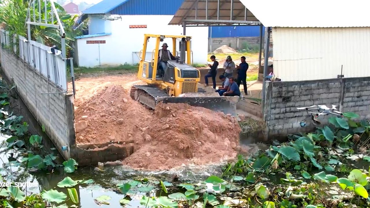 Nicely Landfill by Bulldozer D41P working push soil with dump truck 5T unloading soil into the water