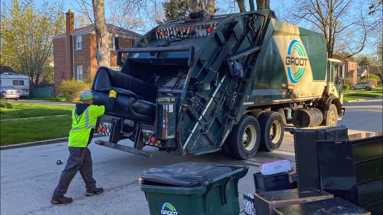 Groot Mack MR McNeilus Rear Loader Garbage Truck Packing Bulk at the Spring Cleanup